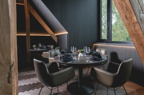 a dining room with two tables and chairs at Lukas Kapeller Hotel und Restaurant in Steyr