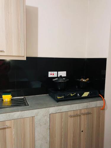 a kitchen with a stove and a counter top at Urban Escape in Nairobi