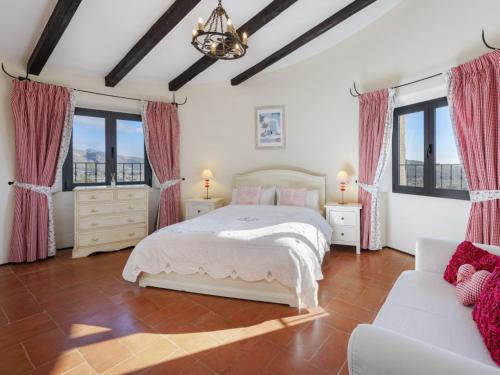 a bedroom with a bed and a couch at SundanceMallorca in Port de Pollensa