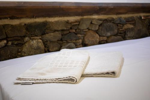 a white towel sitting on top of a bed at Αρχοντικό Αλεξάνδρου in Kakopetria