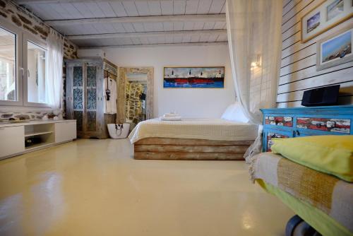 a bedroom with a bed and a blue dresser at Villa Princess 6 private with Pool Panormos Beach in Panormos Mykonos