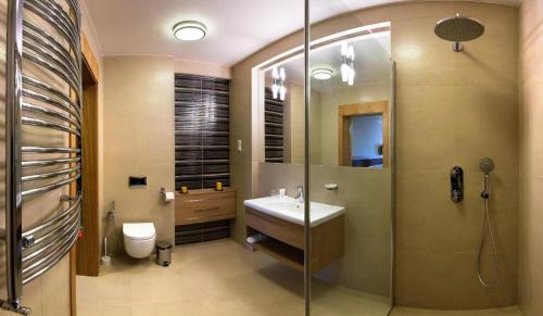 a bathroom with a sink and a shower at Hotel KARO in Radom