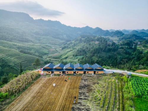 une vue aérienne sur une ferme avec des montagnes en arrière-plan dans l'établissement Lý Thị Chương Homestay & Bungalow, à Bản Kam