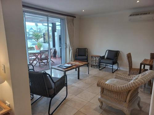 a living room with chairs and a table at 42 Spinnaker, The Quays in Knysna