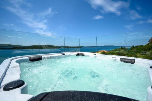 a hot tub with a view of the water at Villa GRC in Zaboric