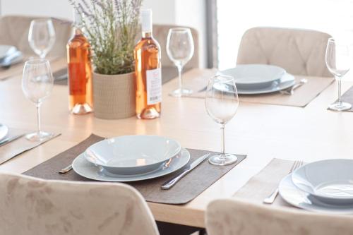 a table with plates and wine glasses on it at Villa GRC in Zaboric