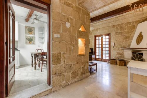 a large room with a stone wall at Charming 4BR House of Character with private pool By 360 Estates in Naxxar