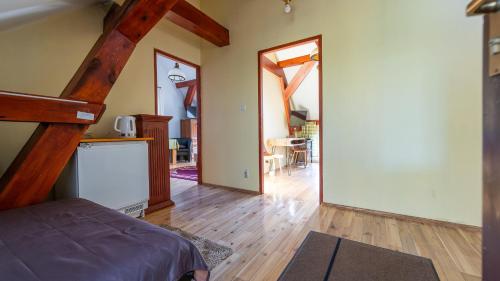 a room with a bed and a hallway with a staircase at Agroturystyka Nad Wartą in Skwierzyna