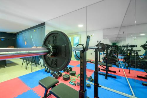 a fitness room with a gym with a barbell at Villa GRC in Zaboric
