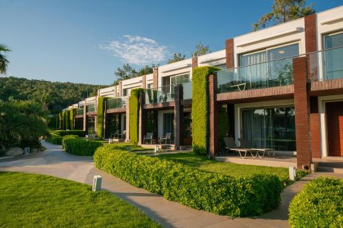a building with ivy on the side of it at Ortunc Hotel - Cunda Island (Adult Only) in Ayvalık
