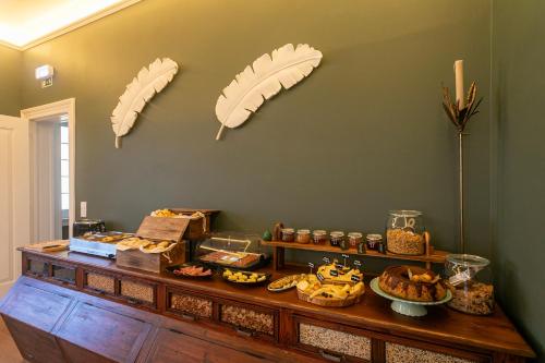 a table with food on it with umbrellas on the wall at Casa Portuguesa - Charming House in Ponta Delgada