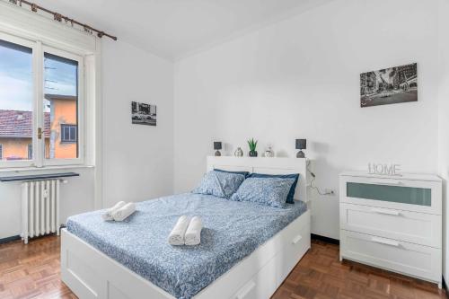 een witte slaapkamer met een bed en een raam bij MI8 -10 minutes from the Duomo- Large Apartment in Milaan