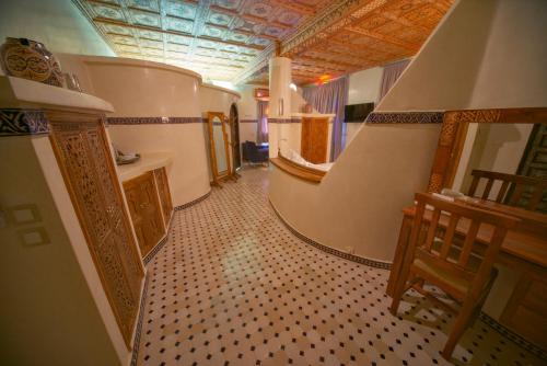 a hallway with a tile floor and stairs in a house at OZ Palace Ouarzazate & SPA in Ouarzazate