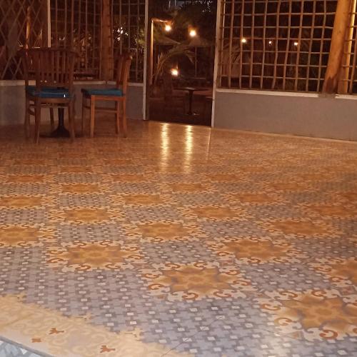 a tile floor in a room with a table and chairs at THE OWN PENIDA COTTAGE & SPA in Nusa Penida