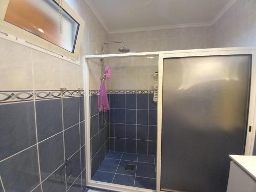 a shower with a glass door in a bathroom at Casa da Montanha in Salão