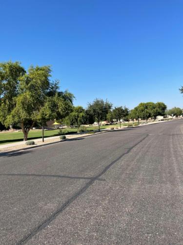 an empty street with trees on the side of the road at Cozy Private room with Shared bathroom Inside a house in Phoenix