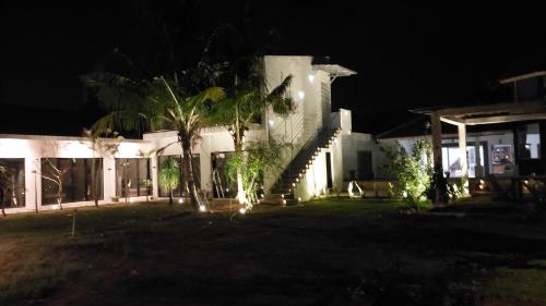 a house at night with lights in the yard at Mercusuar Resort Jepara in Kesembu