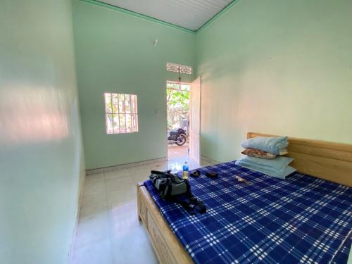 sypialnia z łóżkiem z niebieskim prostotą w obiekcie Gia Bắc Homestay w mieście Di Linh
