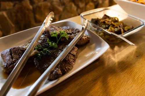 a plate of food with chopsticks on a table at Matatane Camp - Babanango Game Reserve in Nkwalini