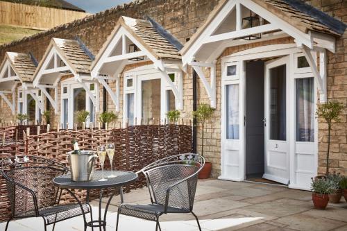 an outdoor patio with a table and chairs at The Fish Hotel in Broadway