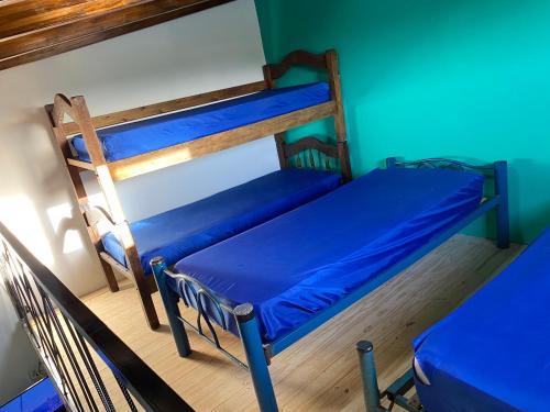 two bunk beds in a room with a blue wall at House-Mendoza in Maipú
