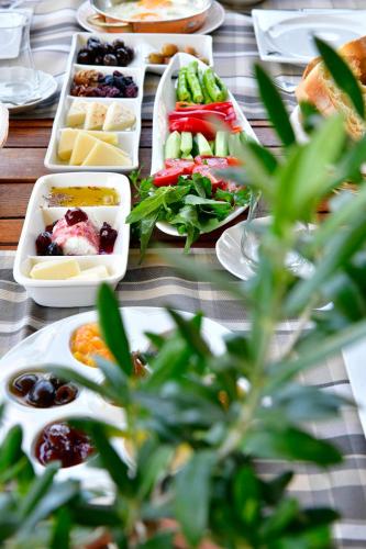a table with many plates of food on it at Siyah Lale Cunda 1841 in Cunda