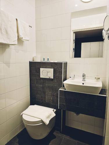 a bathroom with a toilet and a sink at Lidingö Arena Hotel in Lidingö
