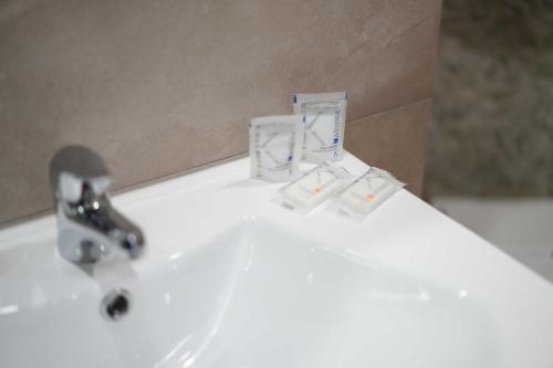 a white sink with a faucet on top of it at Neapolitan Soul By Dimorra in Naples