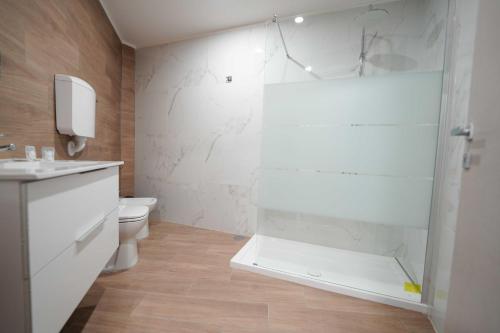a bathroom with a shower and a sink and a toilet at Neapolitan Soul By Dimorra in Naples