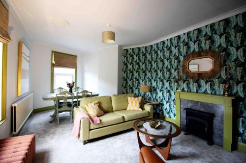 a living room with a couch and a fireplace at The Tree House, quiet neighbourhood in Lincolnshire