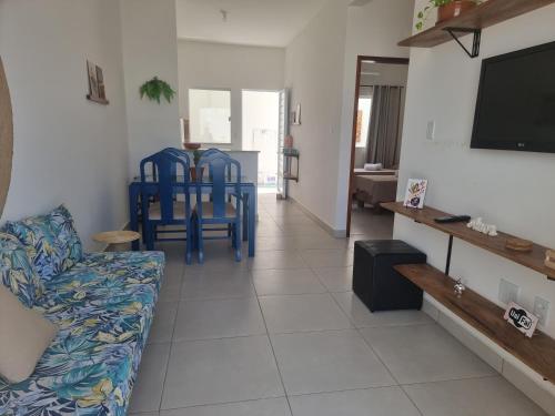 a living room with blue chairs and a couch at Vila Girassol in Aracaju