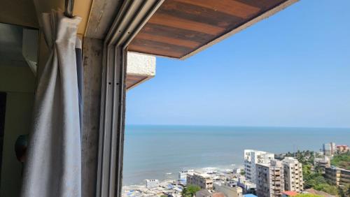 a view of the ocean from a window at Ocean view in Mumbai