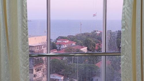 a view of the ocean from a window at Ocean view in Mumbai