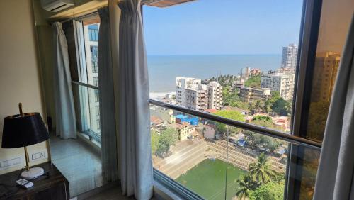a room with a window with a view of the ocean at Ocean view in Mumbai