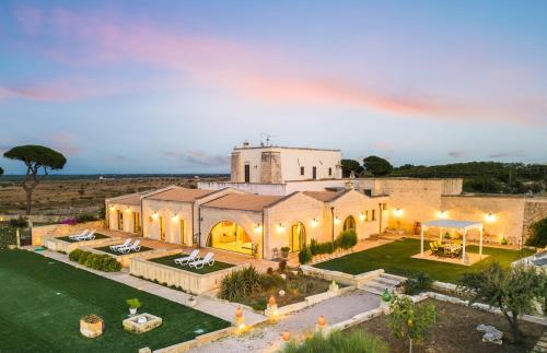 - une vue aérienne sur un grand bâtiment blanc dans l'établissement Masseria Specchia, à Lecce