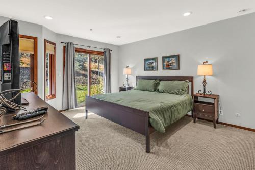 a bedroom with a bed and a desk with a computer at Lakeside Adventure in Park City