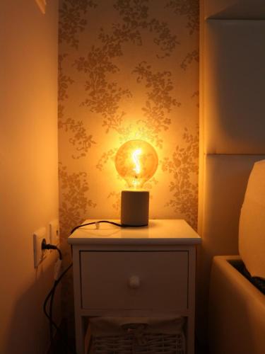 a light on top of a table in a room at Casa do Pinheiro in Fiães