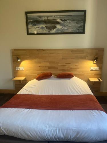 a bedroom with a bed with two pillows on it at Le petit Montmartre in Dinard
