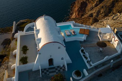 an overhead view of a white house with a pool at Caldera View Private Villa in Megalochori