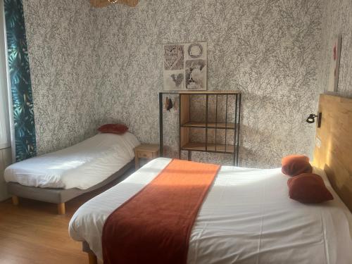 a bedroom with two beds and a shelf with teddy bears at Le petit Montmartre in Dinard
