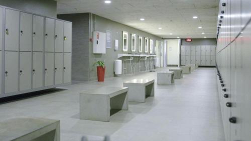 a row of benches in a locker room with lockers at Kings Garden 1 by Daniel&jacob's in Copenhagen
