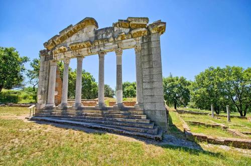 ancient ruins of a building in a field at ELITE LUXURY BOUTIQUE in Fier