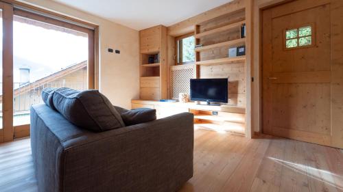 uma sala de estar com um sofá e uma televisão em Sertorelli 27 em Bormio
