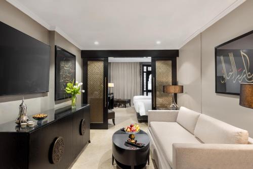 a living room with a couch and a table at Sofitel Shahd Al Madinah in Al Madinah