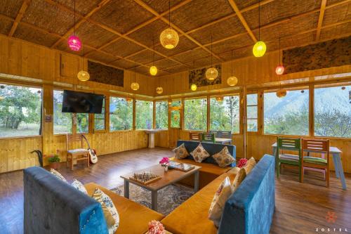 a large living room with couches and a table at Zostel Pahalgam in Pahalgām