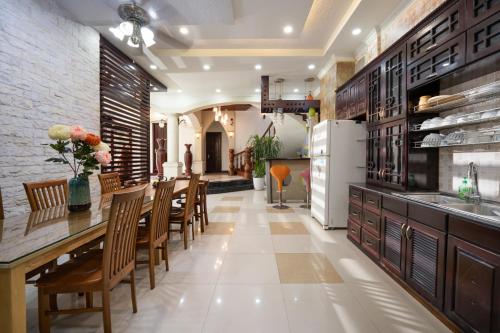 a kitchen and dining room with a table and chairs at S Villa Đà Nẵng Gần Biển in Da Nang