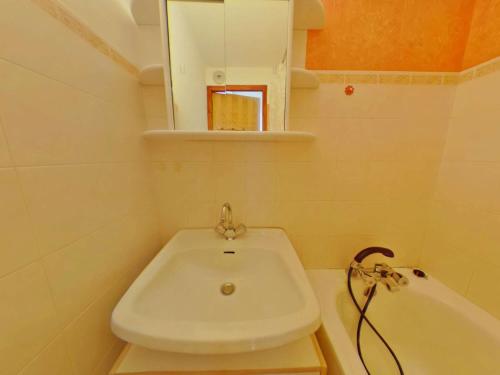 a small bathroom with a sink and a bath tub at Appartement Les Saisies, 1 pièce, 4 personnes - FR-1-594-119 in Hauteluce