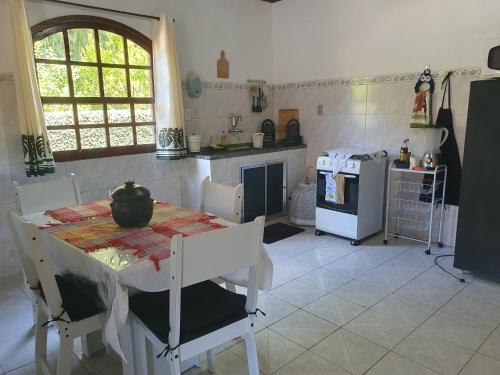 LUMIAR Casa do Sossego 2 Qts Centro Sem escadas Pets Idosos في نوفا فريبورغو: مطبخ مع طاولة عليها قدر