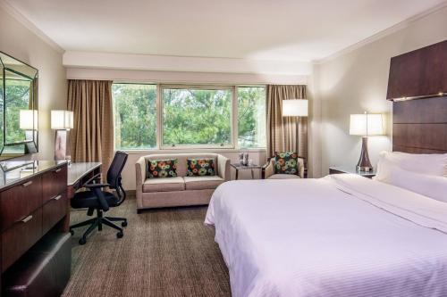 a hotel room with a bed and a desk at The Westin Waltham Boston in Waltham