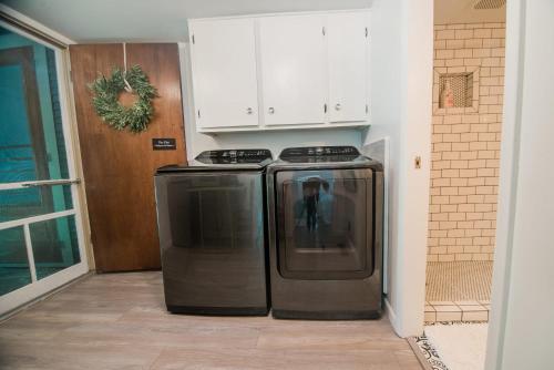 a kitchen with a stove and a refrigerator at The Flat a Wanderlust Abodes property in Central Lake